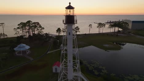 Tight-aerial-orbit-of-orange-sunset-and-beautiful-coastal-views-at-Cape-San-Blas-Lighthouse-in-Port-St