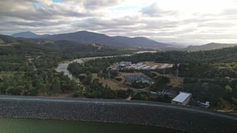 Over-the-lake-and-the-dam-wall-and-revealing-the-works-area-and-the-Goulburn-River-at-Lake-Eildon,-Victoria,-Australia