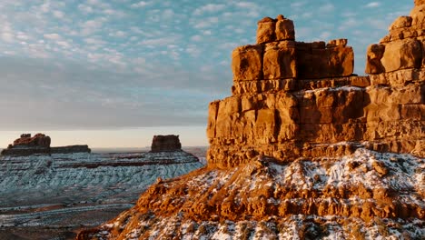 Flying-drone-cinematic-shot-close-to-rock-during-sunrise-Valley-of-the-Gods-Utah