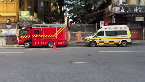 Direct-frontal-view-of-an-ambulance-and-fire-truck-are-on-standby-for-a-rescue-in-Taipei-Wanhua-district,-Ximending,-Taiwan