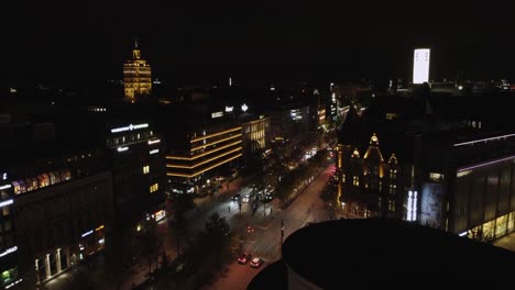 Night-aerial-rises-over-downtown-retail-district-in-Helsinki,-Finland