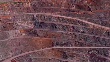 Aerial-drone-shot-of-dirt-roads-on-different-levels-of-terrain-in-Siana-Gold-and-Silver-mine,-Mainit,-Philippines