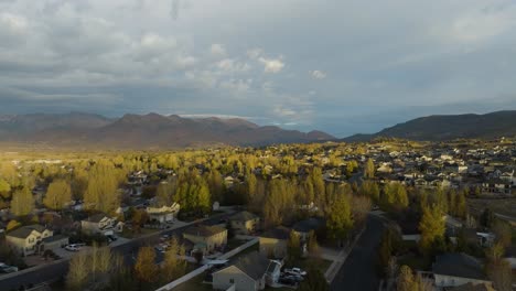 Heber,-Utah-at-sunrise:-town,-mountains,-and-picturesque-valley---aerial-reveal