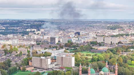 Aerial-panorama-view-of-smoke-in-the-air-with-Bradford-City-during-cloudy-day---Grand-Mosque-in-foreground
