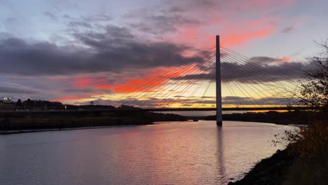 The-Northern-Spire-Bridge-over-the-River-Wear-in-Sunderland,-England-during-a-beautiful-orange-sunset