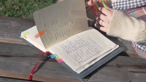 Female-student-looking-through-her-notebook