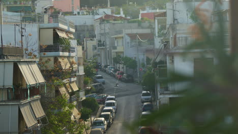 Quaint-urban-street-in-Athens-with-lined-trees-and-cars