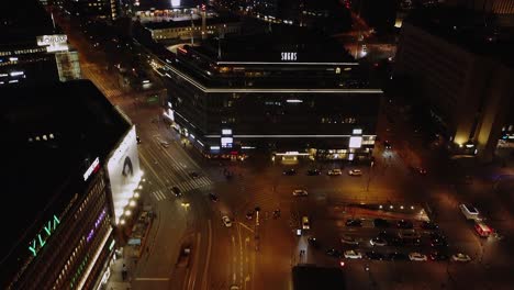 Night-aerial-tilts-up-from-dynamic-shopping-plaza-in-downtown-Helsinki