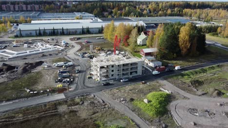 Aerial-pulls-back-from-concrete-building-under-construction-in-Finland