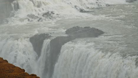 Tilt-up-of-amazing-Gullfoss-waterfall-in-Iceland-on-a-sunny-day-in-slow-motion