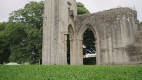 Glastonbury-Abbey-ruins-central-part,-camera-pan-bottom-to-top-4k-slow-motion