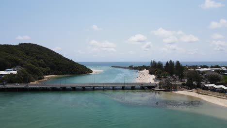 Scenic-drone-view-following-along-the-Tallebudgera-Creek-to-Burleigh-Head-National-Park-and-Pacific-Ocean