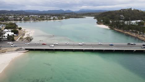 Unique-drone-view-following-along-the-scenic-Tallebudgera-Creek-and-over-the-Gold-Coast-Highway-bridge