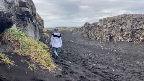 Woman-peacefully-walking-between-North-America-and-Eurasia-tectonic-plates-in-Iceland