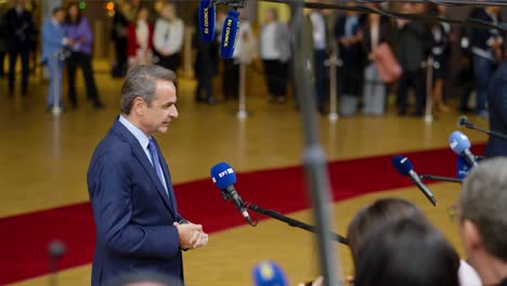 Greek-Prime-Minister-Kyriakos-Mitsotakis-giving-a-statement-at-the-European-Council-summit-in-Brussels,-Belgium---Profile-shot,-slow-motion