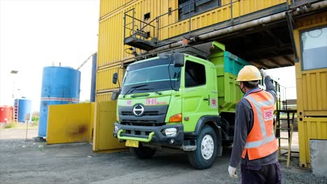 Truck-has-been-filled-with-mixed-and-homogeneous-aggregate-into-the-transport-truck-by-opening-the-opening-door-at-the-bottom-of-the-mixer-with-hydraulic-control-at-the-Asphalt-Mixing-Plant-factory