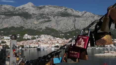 Love-locks-and-view-of-seaside-town-by-mountains,-symbol-of-couple-in-love