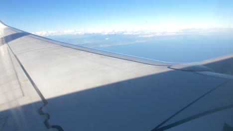 Airplane-flying-over-the-clouds-wing-view