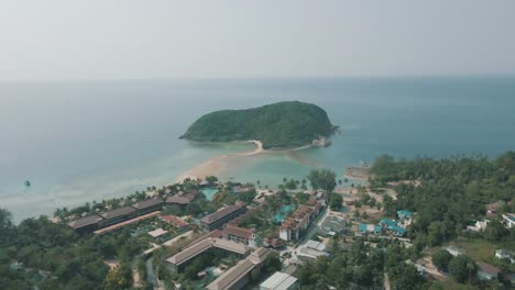 Epic-drone-footage-of-a-beach,-resort-and-small-island-off-the-coast-of-Koh-Phangan-Thailand