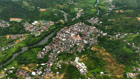 High-altitude-drone-shot-orbiting-the-San-Rafael-Village,-in-cloudy-Colombia