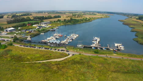 Aerial-panoramic-view-of-drone-flying-to-yachts-in-marina,-Blotnik,-Pomeranian,-Poland
