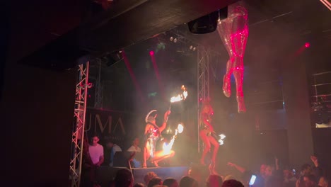 Amazing-fire-dancers-in-Yuma-Dreamers-club-Marbella,-people-dancing-to-music-and-having-fun,-nightlife-in-Marbella,-best-party-vibes-in-Spain,-dangerous-fire-performance,-4K-shot