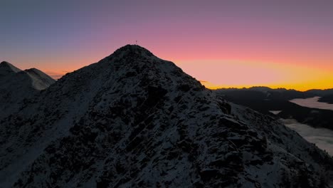 Pre-dawn-glow-over-snowy-Italian-peaks,-captured-by-drone