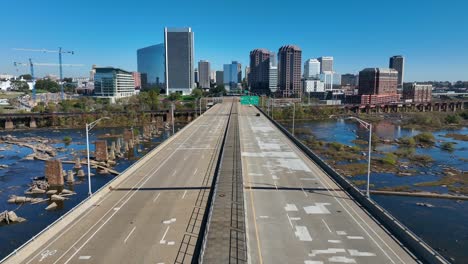 Aerial-shot-of-downtown-Richmond,-Virginia-as-seen-from-Manchester-Bridge-crossing-the-James-River