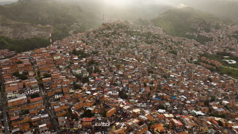Aerial-view-overlooking-a-hillside-of-poor-dwellings-in-Comuna-13,-Colombia