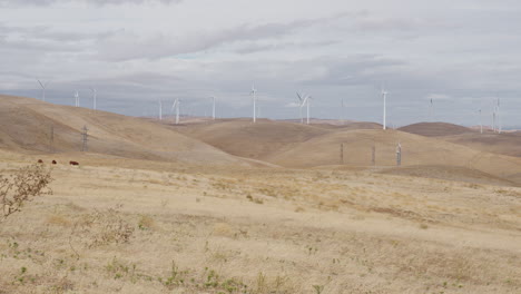 Wide-shot-windmills-and-dry-hills-with-clouds