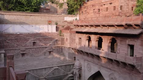 ancient-red-stone-unique-stepwell-architecture-at-day-from-different-angle-angle-video-is-taken-at-Toorji-ka-Jhalra-or-stepwell-jodhpur-rajasthan-india