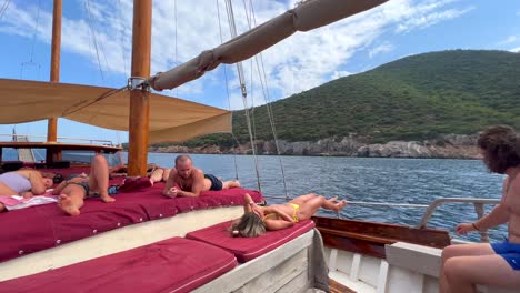 Friends-chilling-and-relaxing-on-a-big-boat-in-Bodrum-Turkey,-fun-summer-vacation-with-friends,-luxury-holiday-destination,-sunny-sea-view,-4K-shot