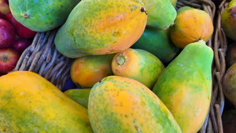 Exotic-big-fresh-sweet-papayas-from-the-local-farm-for-sale-at-an-organic-farmers-market,-healthy-bio-fruits,-4K-shot