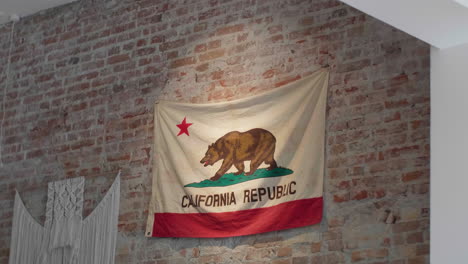 California-state-flag-on-a-rustic-brick-wall-backdrop