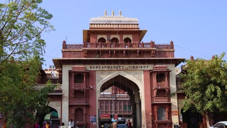 people-walking-at-city-street-near-historic-entrance-gate-at-day-from-different-angle-video-is-taken-at-sardar-market-ghantaGhar-jodhpur-rajasthan-india-on-Nov-06-2023