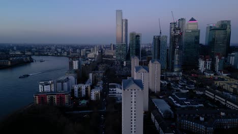 Blue-hour-aerial-view-of-Canary-Wharf-and-Docklands-on-River-Thames-bank,-London
