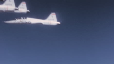 1960s-USAF-T-38-Talon-Jet-Planes-Flight-in-Formation-in-Blue-Sky---Cockpit-POV