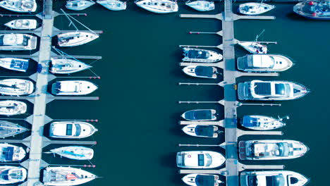 Aerial-top-down-shot-of-parking-motorboat-and-sailing-boats-in-marina-of-Gdynia,-Poland