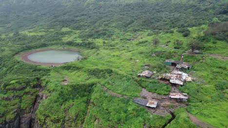 Panoramic-aerial-view-of-sacred-lake-at-the-Brahmagiri-hill-in-the-Western-Ghats-of-Maharashtra-during-monsoon,-Nashik,-India