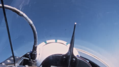 Vintage-Mid-Century-Sky-View-from-Military-Cockpit-with-Pilot-Helmet