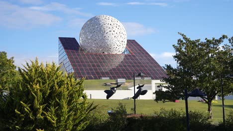 Astra-Fun-Experiences-building-with-giant-sphere-design-at-Futuroscope-theme-park-containing-slides,-Wide-shot