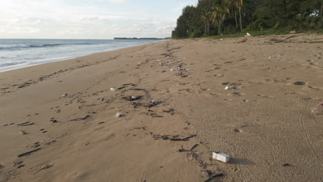 A-beautiful-sandy-beach-that-is-littered-with-washed-up-plastic-and-other-rubbish