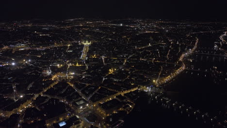 Prague-Czechia-Aerial-v101-high-altitude-flyover-Vltava-river-capturing-panoramic-views-of-night-cityscape-across-downtown,-old-and-new-town-neighborhoods---Shot-with-Mavic-3-Cine---November-2022