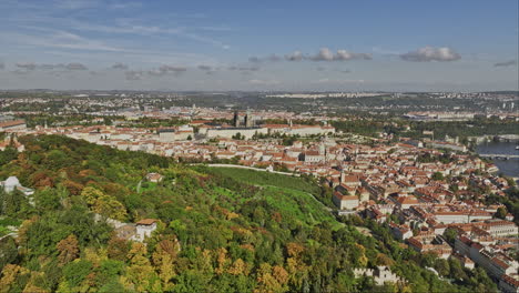Prague-Czechia-Aerial-v42-flyover-Petrin-hill-capturing-scenic-gardens-and-park,-overlooking-at-Hradčany-hilltop-castle,-Old-town-cityscape-across-Vltava-river---Shot-with-Mavic-3-Cine---November-2022