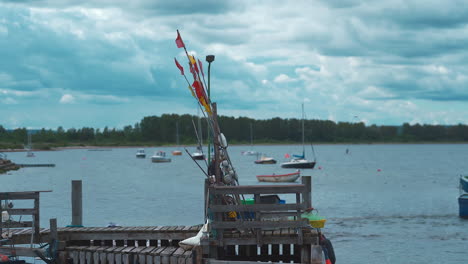 fishing-pier-with-fishing-flags-on-top,-sea-in-the-background
