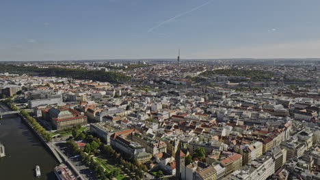 Prague-Czechia-Aerial-v48-drone-flyover-Vltava-river-capturing-cityscape-across-Karlin,-Zizkov,-Florenc,-Vinohrady-and-New-Town-neighborhoods-on-a-sunny-day---Shot-with-Mavic-3-Cine---November-2022