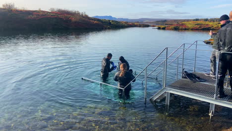 Client-trying-snorkeling-with-a-diving-school-in-the-cold-waters-of-Silfra,-Iceland
