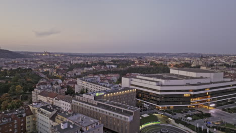 Prague-Czechia-Aerial-v126-fly-around-Congress-centre-located-on-the-edge-of-Nusle-Valley-capturing-modern-building-exterior-and-Vinohrady-cityscape-at-dusk---Shot-with-Mavic-3-Cine---November-2022