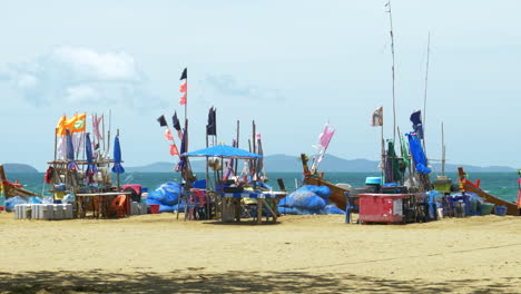 A-fishing-area-in-Pattaya-where-fishermen-gather-with-their-fishing-boats,-nets,-and-other-equipment-like-ice-boxes,-tables,-and-chairs-for-sorting-their-catch-for-the-day,-in-Chonburi,-Thailand