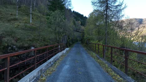Crossing-old-railway-bridge-at-Stavenes,-decommissioned-Bergen-railway,-Norway